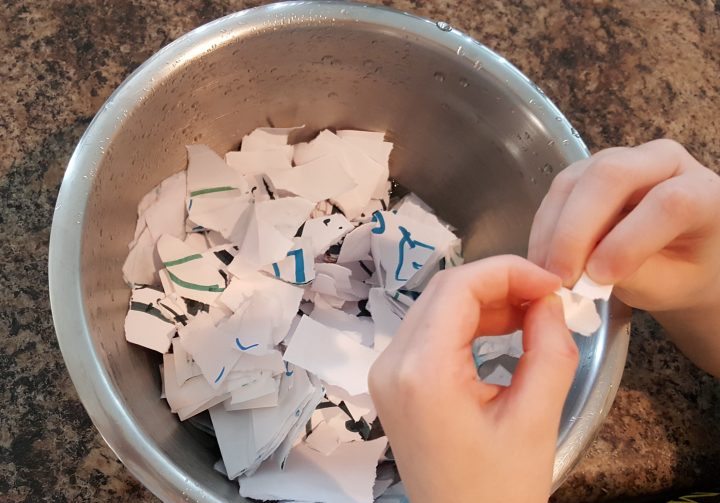 craft ideas for kids shows a child ripping paper into a bowl.