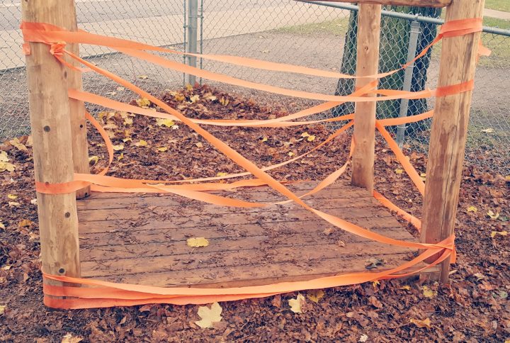 outdoor play shows orange streamers around an outdoor structure.