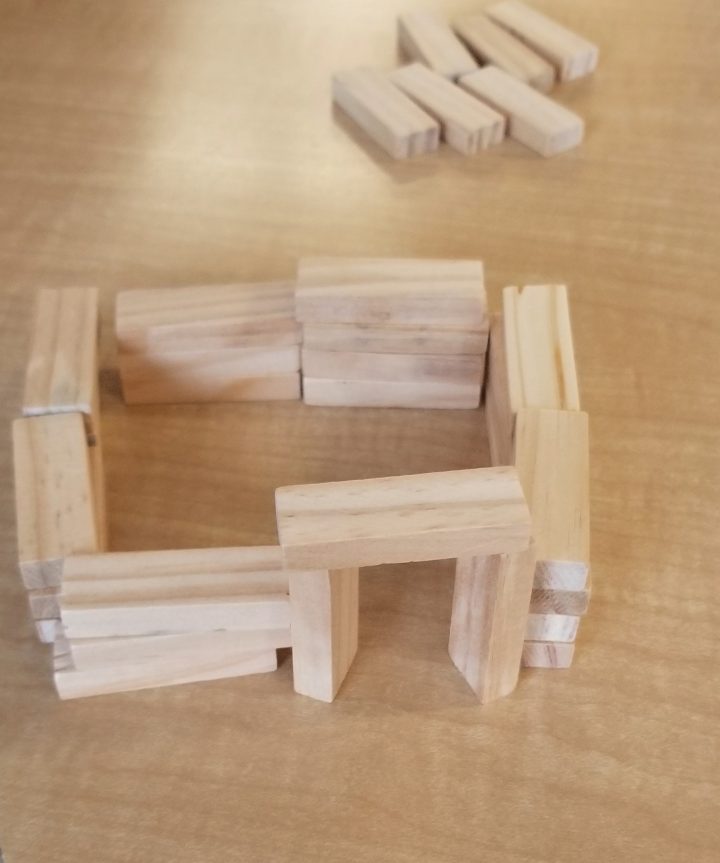 STEM activity shows a little house made from wooden blocks.