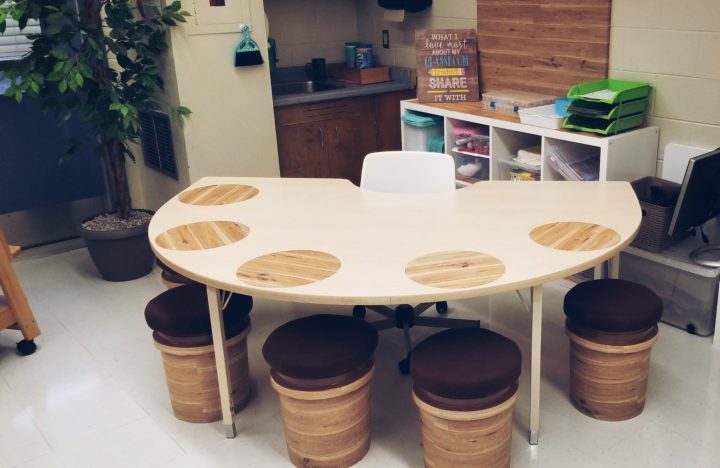 classroom shows a reading table with chairs for kids.