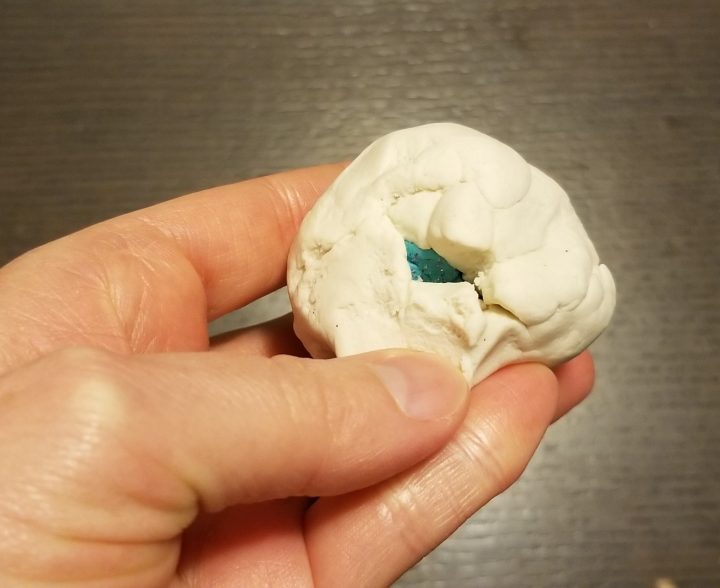 memorable first day of school activity shows a ball of white playdough with blue ball inside.