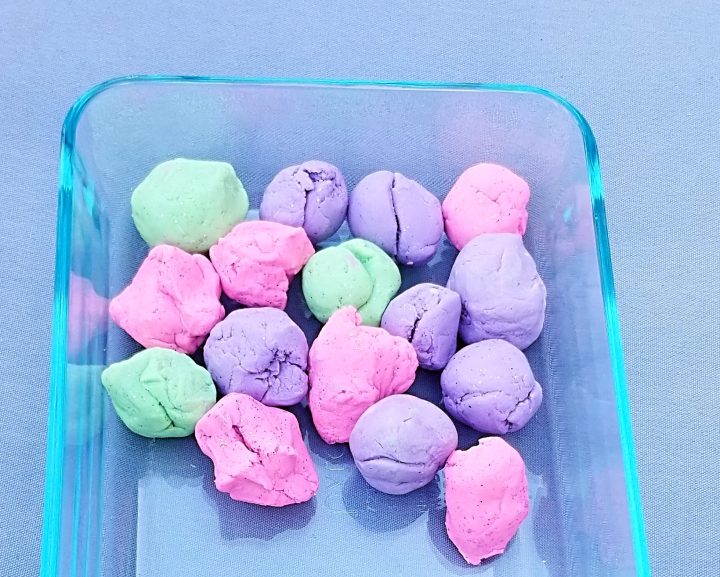 memorable first day of school activity shows a container with pink, purple and green dough.
