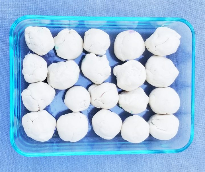 first day of school ideas shows a container filled with twenty white balls of playdough.
