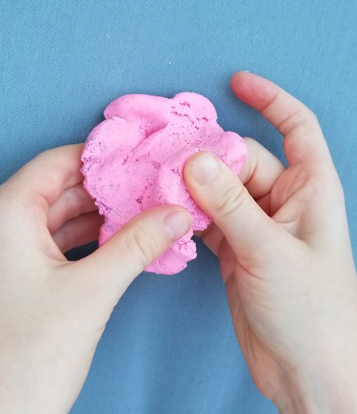 first day of school activity shows a child playing with pink playdough.