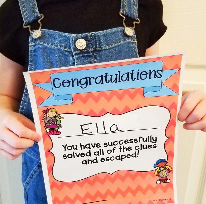 escape room for kids shows a child holding a completion certificate.
