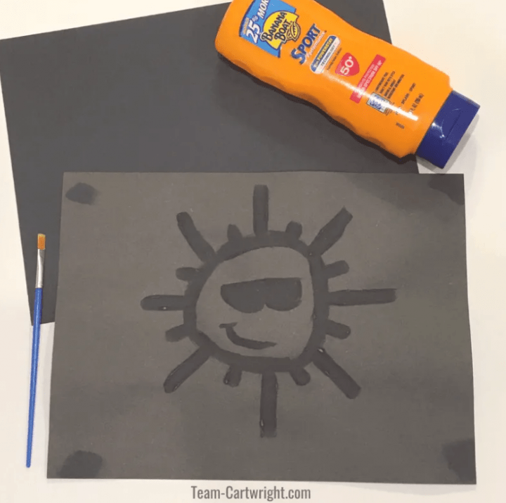 educational activity shows a sun image on a faded piece of black paper.