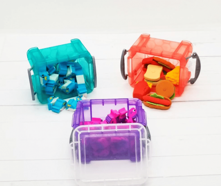 school supplies shows three little containers with mini erasers filling them.