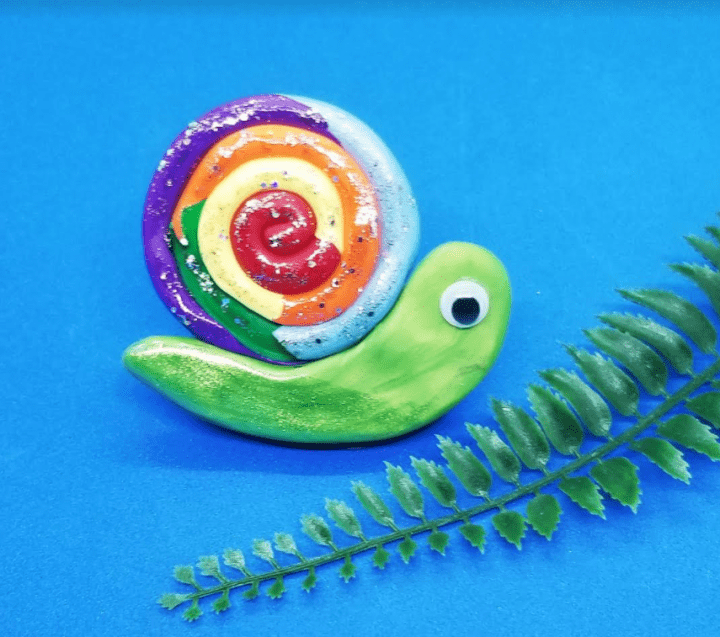 easy clay animals shows a colorful snail made out of clay,.