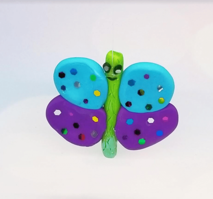 clay animals shows a colorful butterfly.