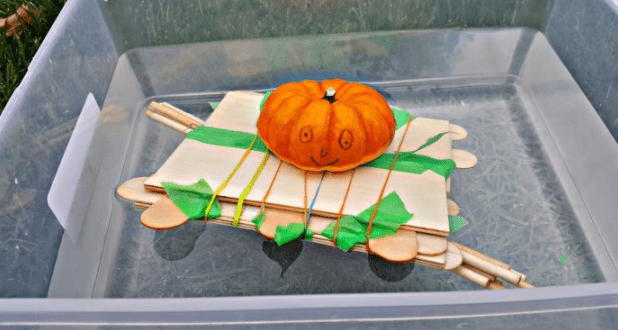 fall stem challenge shows a mini pumpkin floating in a bucket of water and on a wooden boat. 