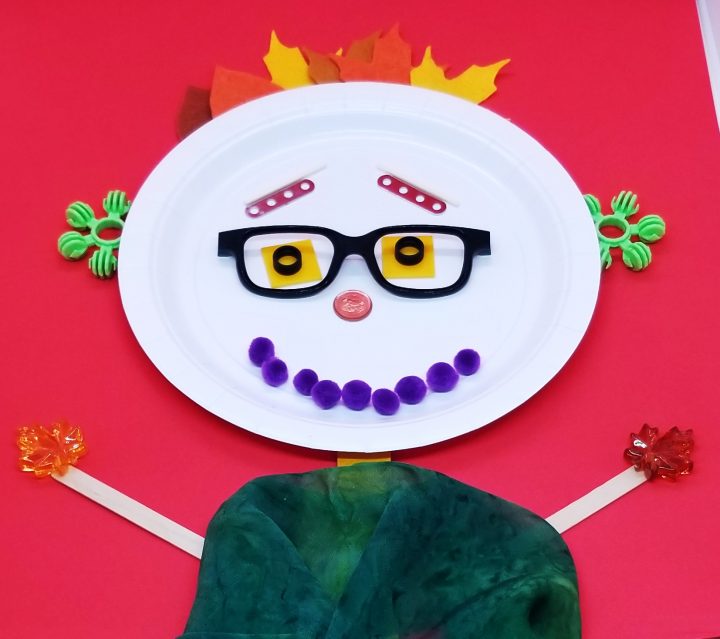 object art for kids shows a person made from a plate, sticks, pompoms etc.