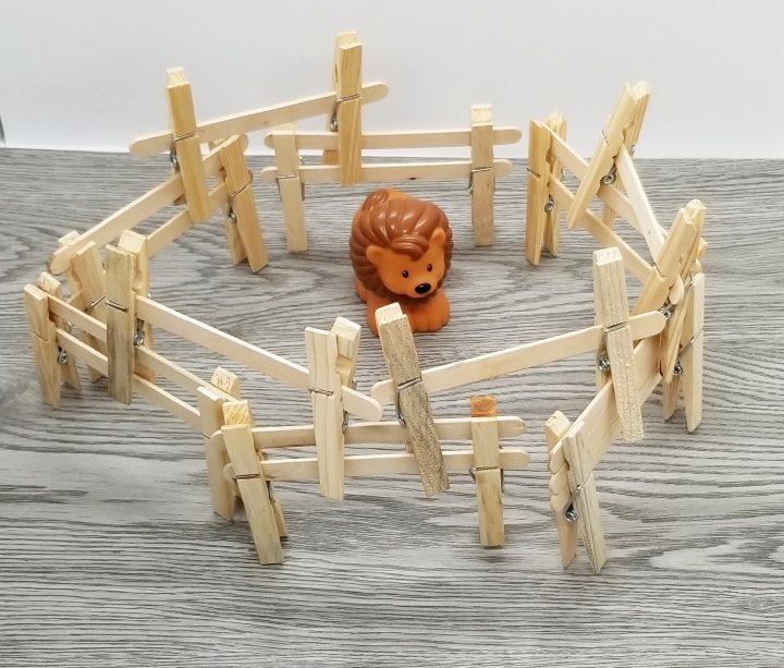 STEM for kids shows a toy lion in a popsicle stick home.