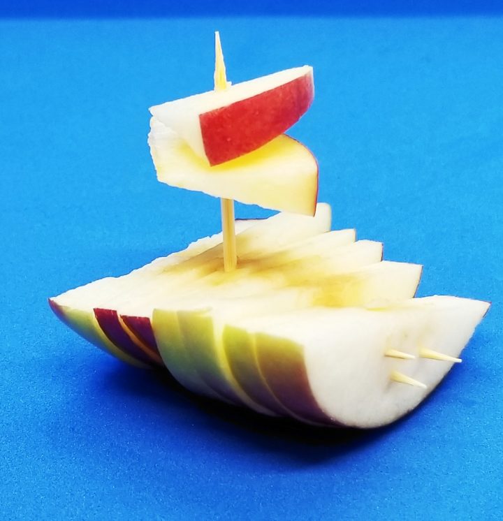 apple boats shows a little boat made from apple slices and tooth picks.