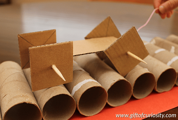 STEM challenges shows a ramp made from paper tower rolls.