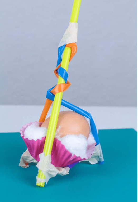 STEM challenges shows an egg drop structure made from straws and cupcake liners.
