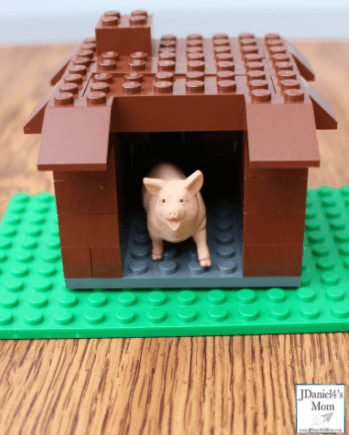 STEM challenges shows a Lego house for a plastic pig.