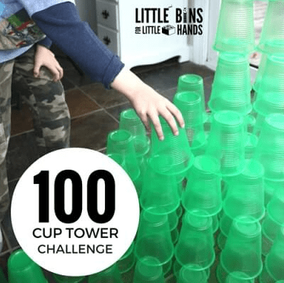 STEM activity shows a child building with plastic cups.