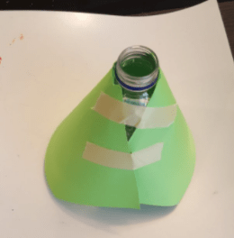diy volcano shows a water bottle with a volcano looking cover.