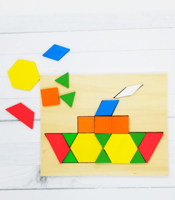 math activities for preschool and kindergarten shows tangram pieces on a wooden board with a boat picture.