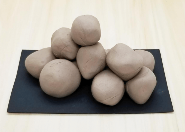 nature art shows a pile of balls of clay.
