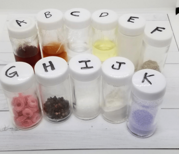 science experiments for kids shows jars labelled A-K each with different stuff.