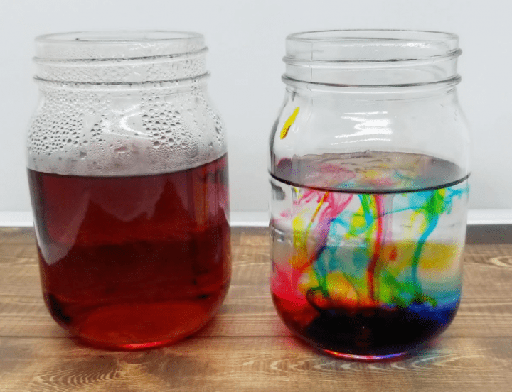 science experiments for kids shows two jars with red liquid in one and swirls of liquid in the other.