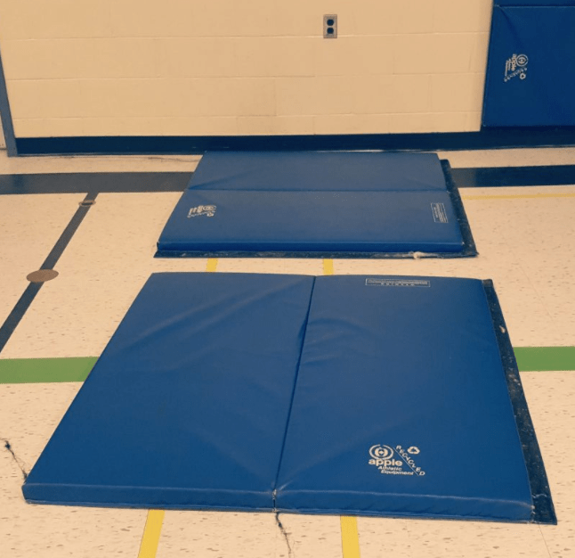 gym games for kindergarten shows two blue mats.