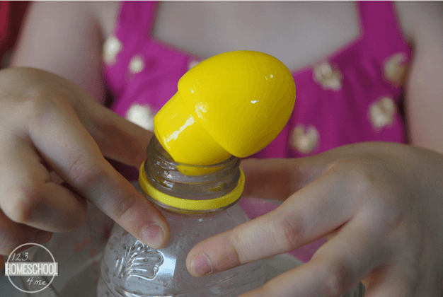 science experiments for kids shows a jar with a yellow lid popped off.