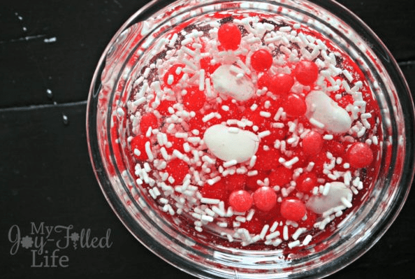 science experiments at home for kids shows a dish with red and white bits in it.
