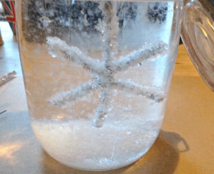 stem for kids shows a clear jar of water with a crystalized snowflake inside.