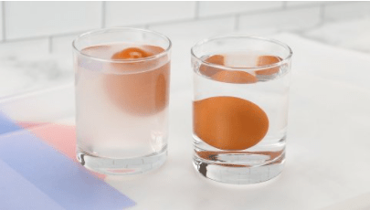 science experiments for kids shows two cups each with an egg inside.