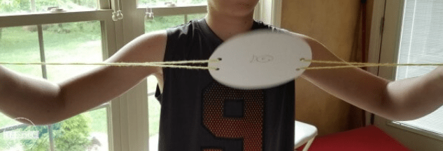 stem for kids shows a child holding string s with an oval cut out in the middle.