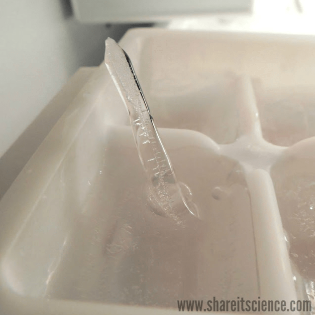 cool science experiments for kids shows a small icicle poking out of a container.