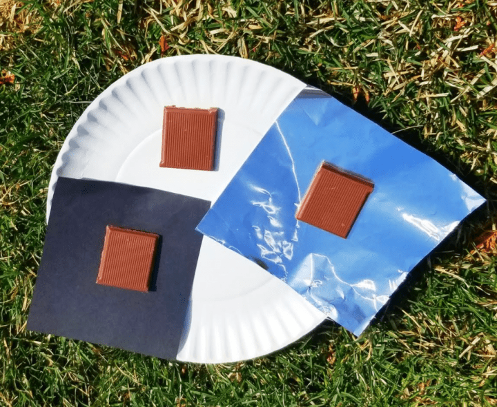 summer stem activities shows three squares of chocolate on three different materials sitting in the sun