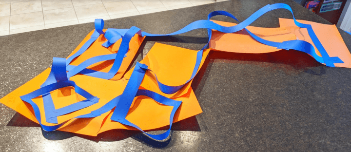 stem activity shows a orange and blue roller coaster made from construction paper.