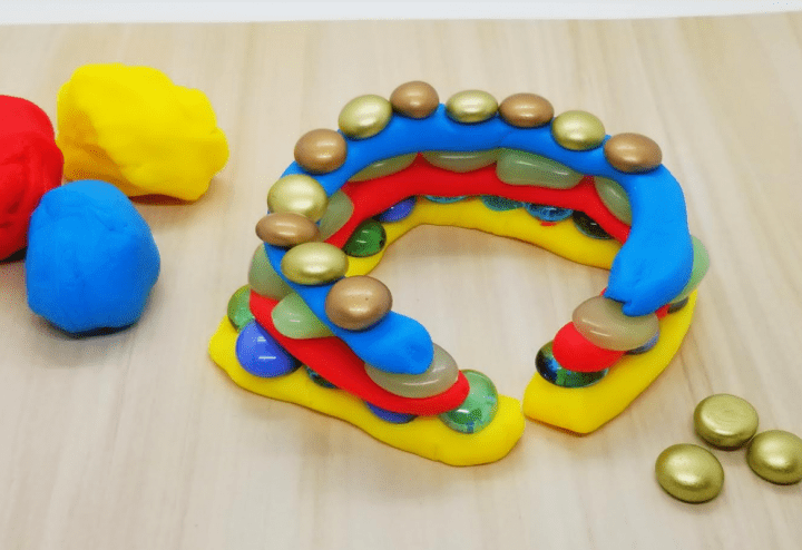 STEM activity shows a structure made from playdoh and gems.