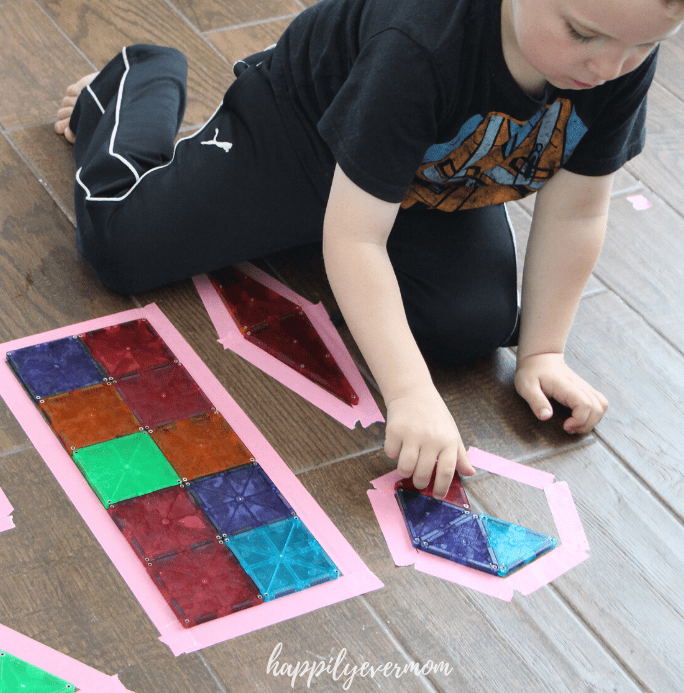 puzzles for kids shows child playing with tangram puzzle pieces.