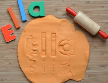 diy puzzles for kids shows a puzzle made from letter stamps and playdough.