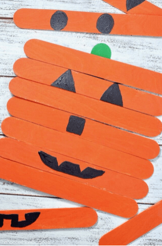 puzzles for kids shows a pumpkin puzzle out of popsicle sticks.