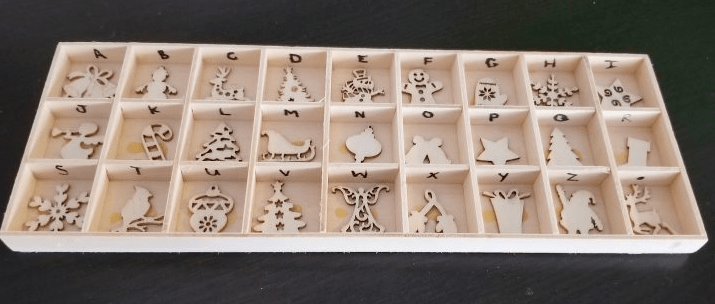 diy puzzles for kids shows a alphabet puzzle with wooden shapes in each section.