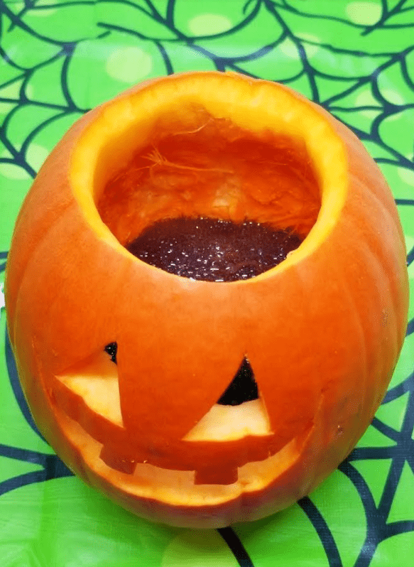 science experiment for kids shows a jack o lantern.