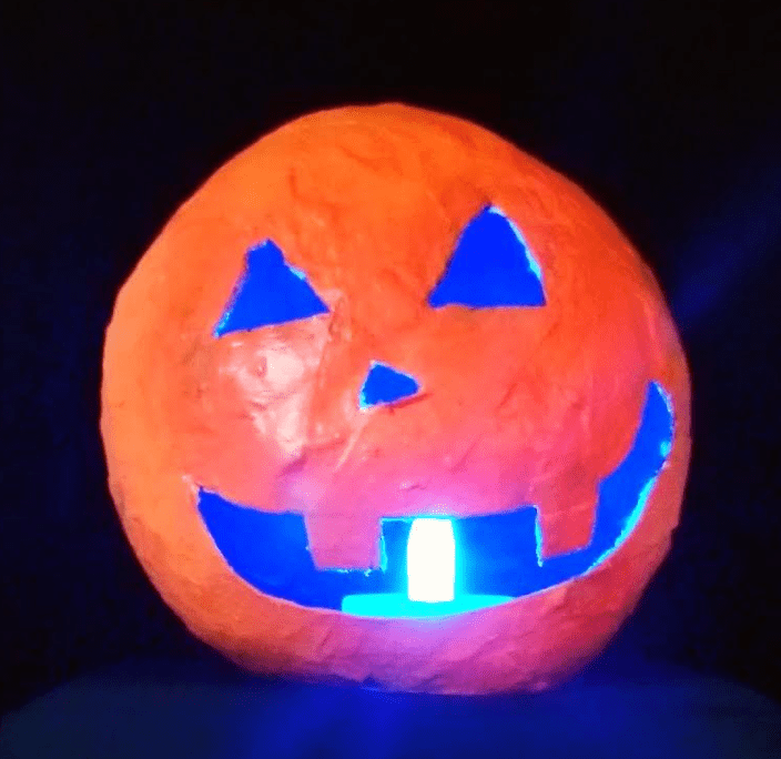 Halloween craft  for kids shows a paper mache jack o lantern.