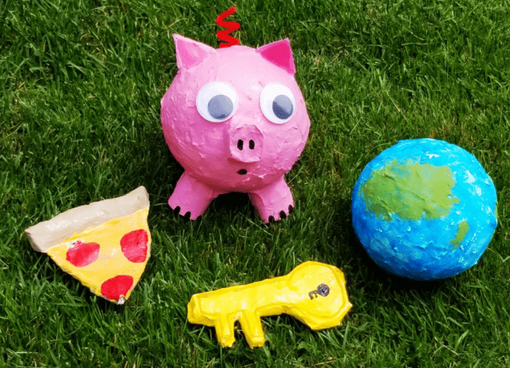 paper mache art ideas shows a pig, pizza, key and globe all made from paper mache