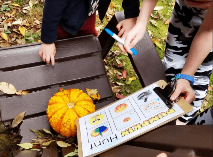 fall outdoor learning activities shows a pumpkin hunt and a child holding a printed pumpkin scavenger hunt. 