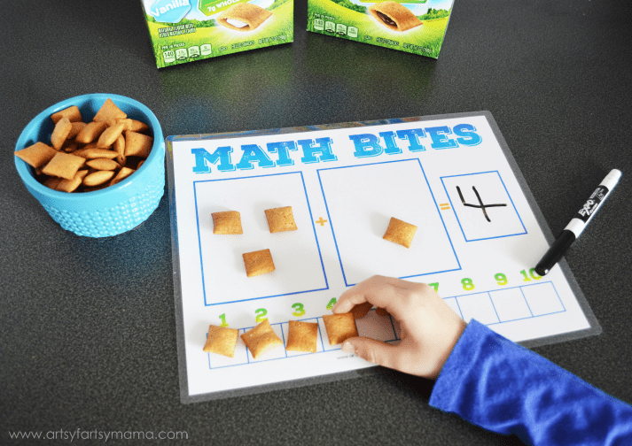 free printables shows a child putting crackers on a math sheet to match the number.