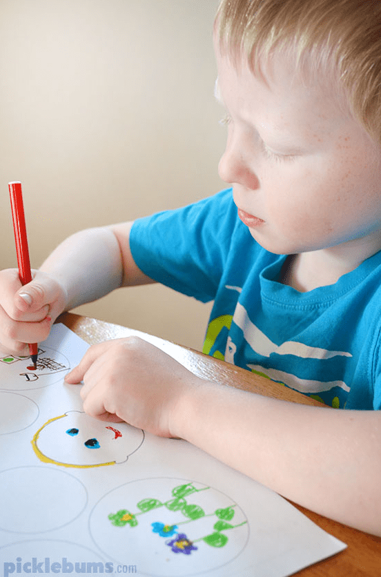 new years eve activities for families and a child holding a marker and drawing in a few circles.