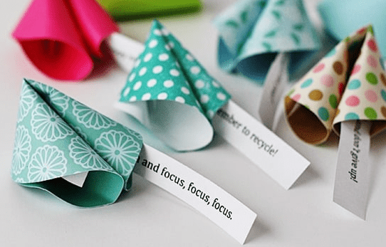 new years eve party ideas and five fortune cookies made from paper and part of the fortune hagding out.