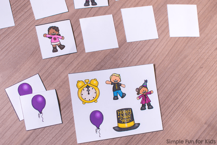 new years eve party ideas and some blank cards and a few cards face up showing celebration images such as people dancing, a hat and a clock. 