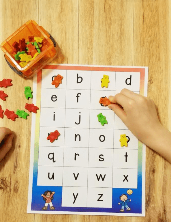 phonemic awareness shows an alphabet card with erasers covering some letters.