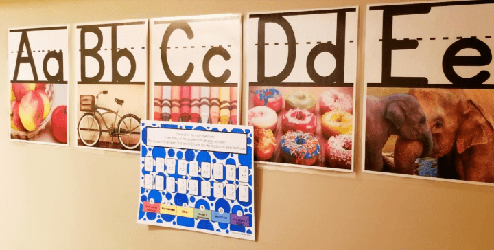 school critical thinking game shows alphabet charts and a puzzle printed and taped in front.